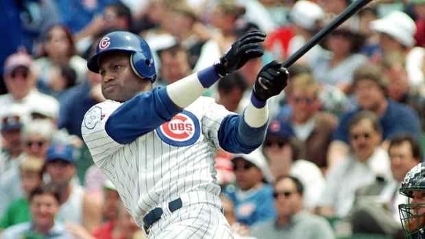 The Chicago Cubs' Sammy Sosa blasts his 25th of the year against the Milwaukee Brewers at Wrigley Field in on June 17, 1998 in Chicago, Illinois.