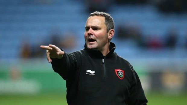 A male rugby coach issuing instructions on sideline.