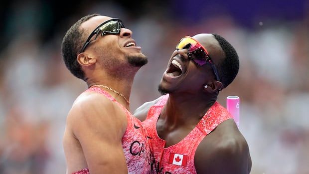 Aaron Brown and Andre DeGrasse embrace