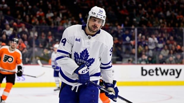 A male hockey player on the ice.