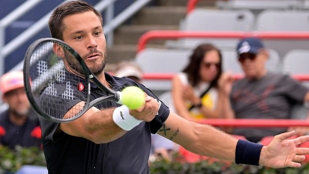 Canadian men's tennis player Alexis Galarneau hits a forehand against Rinky Hijikata of Australia, not pictured, in National Bank Open first-round qualifying play at IGA Stadium in Montreal on August 5, 2024. 