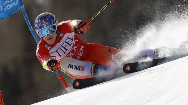 A men's skier veers around an obstacle.