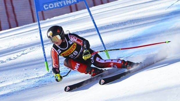 A women's downhill skier competes.