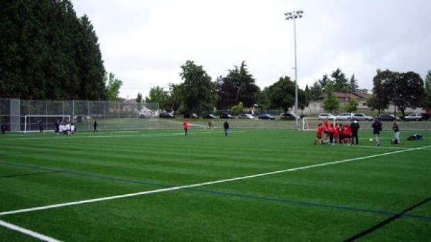 A soccer practice field with a group of players in red shirts.