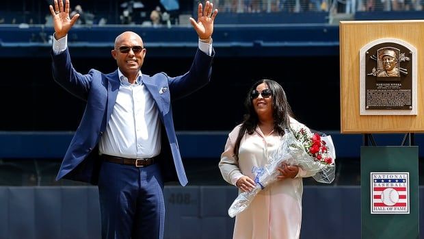 National Baseball Hall of Fame inductee and former New York Yankee Mariano Rivera acknowledges the crowd as he stands with his wife Clara next to his Hall of Fame plaque during a ceremony in his honour at Yankee Stadium on August 17, 2019 in New York City. 