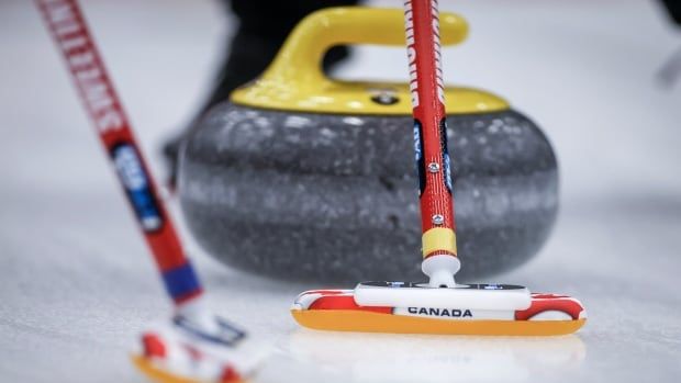 Curling brooms are shown.