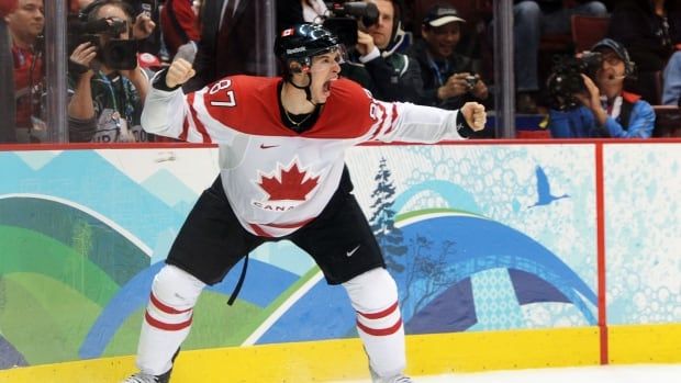 A men's hockey player celebrates a goal.