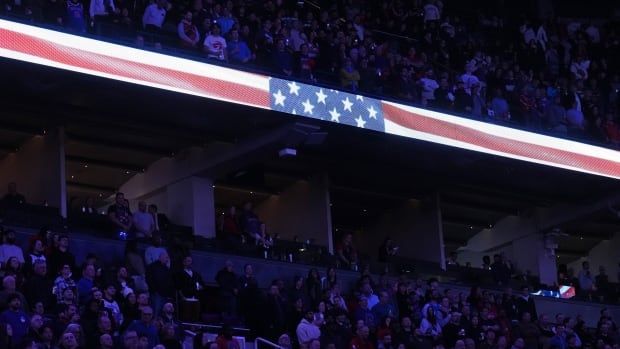 Fans stands during national anthem.