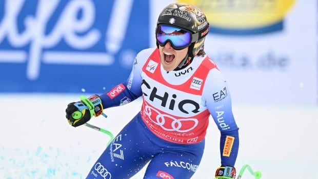 A women's alpine skier yells in celebration.