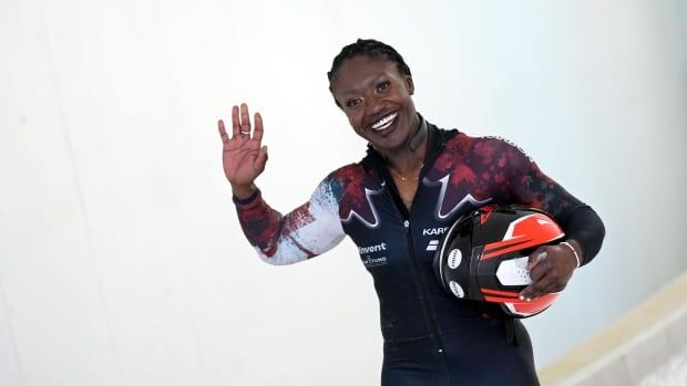 A female bobsledder smiles after her run.