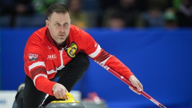 A men's curling skip delivers a rock.