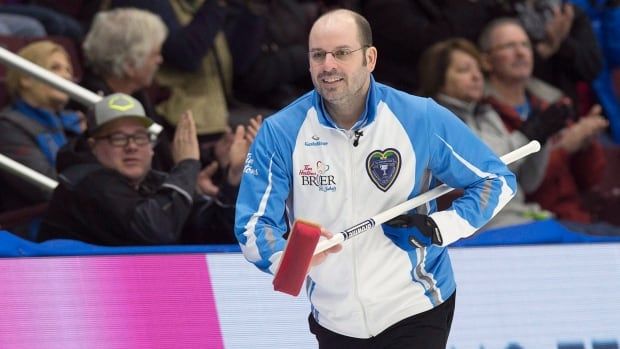 A male curler at a tournament.