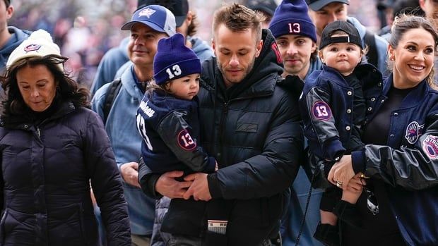 The family of late Columbus Blue Jackets forward Johnny Gaudreau, Jane, left, Meredith, right, and his children walk to Ohio Stadium before a NHL regular-season game against the visiting Red Wings on March 1, 2025. 