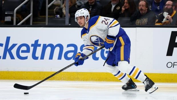 A hockey player stickhandles the puck.