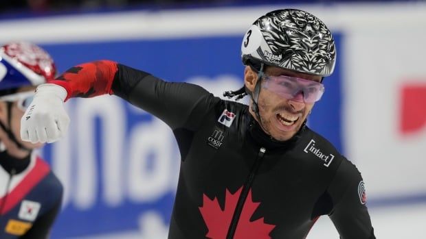 A men's skater celebrates after a race.