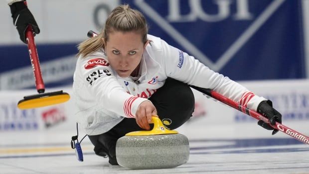 Female curler lunges down to launch rock