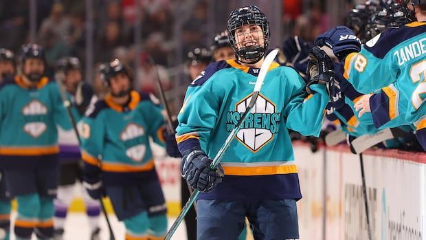 Women's hockey player celebrating a goal