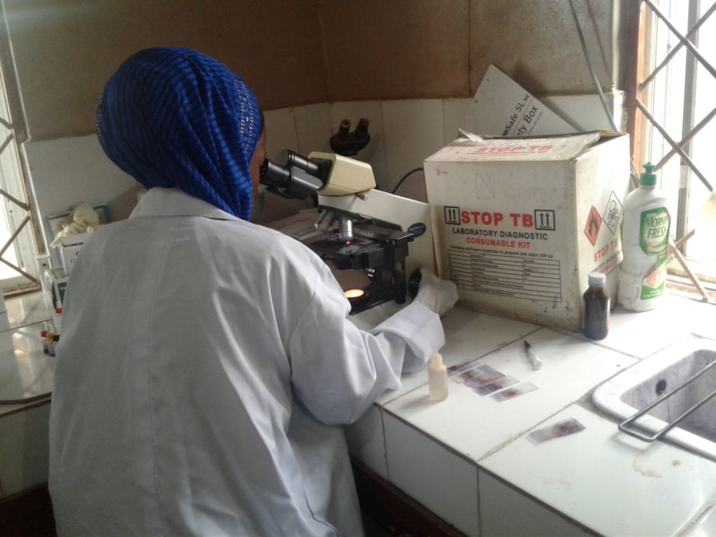 A Laboratory technician in one of the PHCs Kano using microscopy