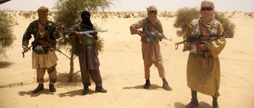 Fighters from Boko Haram group Ansaru stand guard during a hostage handover