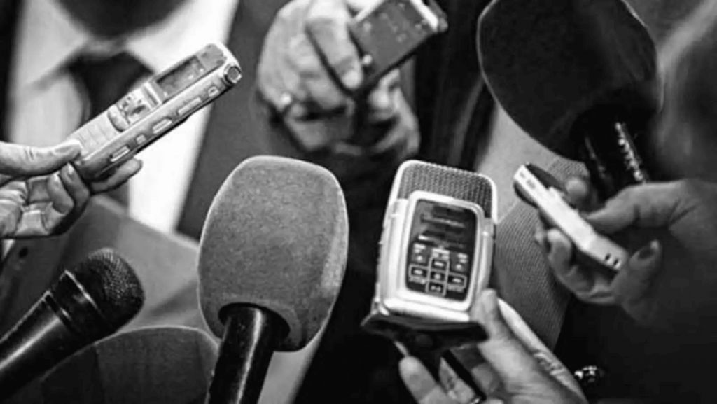 A stack of microphones, signifying an illustration of Journalists