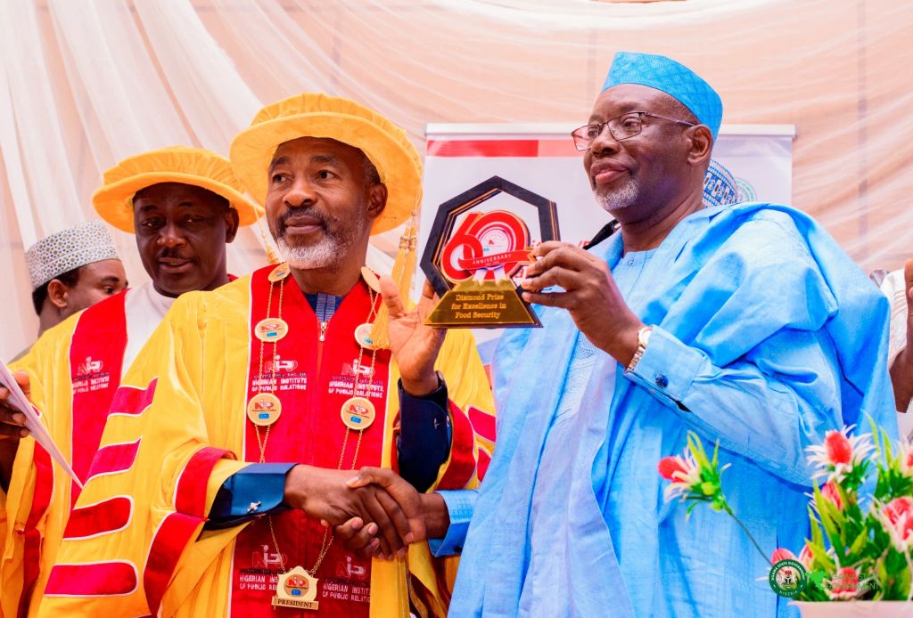 Governor Namadi holding aloft his Diamond Prize, NIPR president, Dr Ike Neliaku and NIPR vice president, Emmanuel Dandaura during the award presentation ceremony