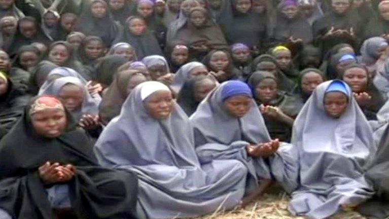 FILE PHOTO: A screengrab taken on May 12, 2014, from a video of Nigerian Islamist extremist group Boko Haram obtained by AFP shows girls, wearing the full-length hijab and praying in an undisclosed rural location. Boko Haram released a new video on claiming to show the missing Nigerian schoolgirls, alleging they had converted to Islam and would not be released until all militant prisoners were freed. A total of 276 girls were abducted on April 14 from the northeastern town of Chibok, in Borno state, which has a sizeable Christian community. Some 223 are still missing. AFP PHOTO / BOKO HARAM