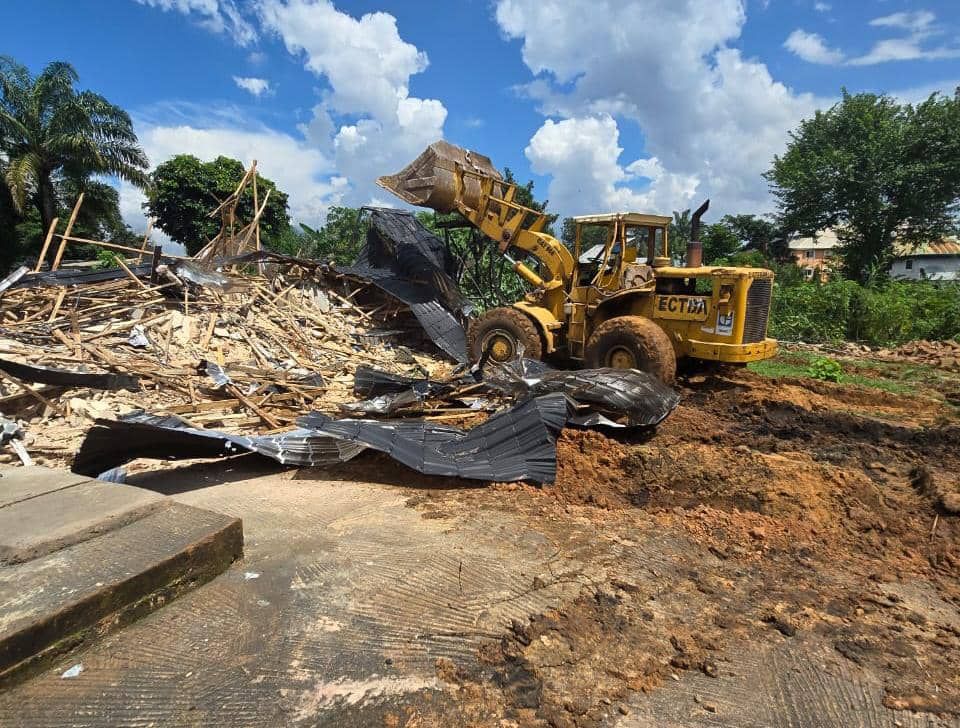 Excavator carrying out the demolition