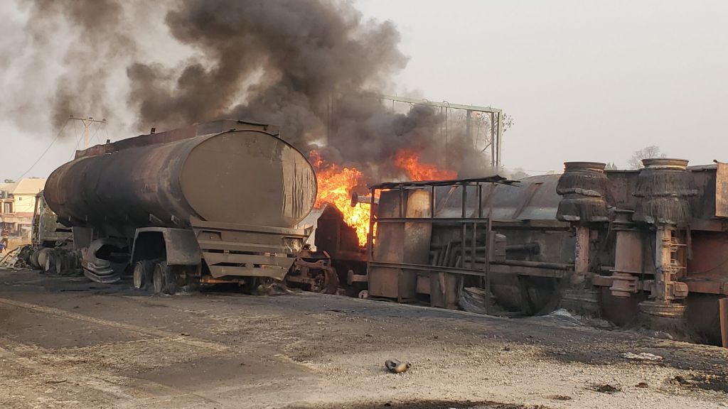 The scene of the incident as of 18 January. The 60,000-litre petrol-laden tanker, with registration number KBG-103-XAX, was heading to Gwagwalada in the Federal Capital Territory from Lagos when it detached from its head. The drivers and members of some regulatory agencies brought another tanker to evacuate the fuel using a pumping machine. Some residents also trooped in to scoop up the spilling fuel when the tanker exploded into a ball of flames. / PHOTO: Yakubu Mohammed