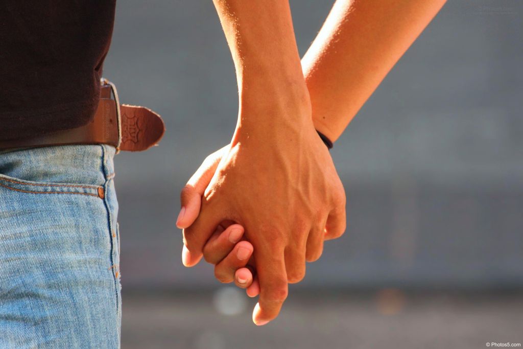 A man and woman holding hands