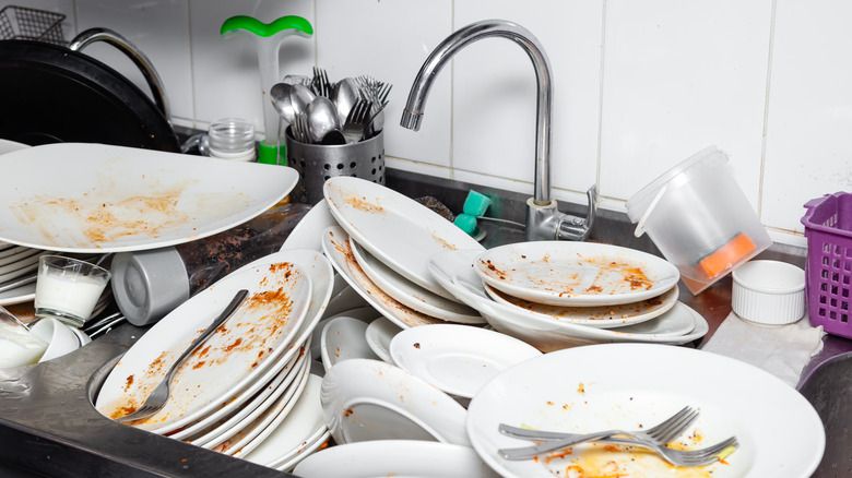 You shouldn’t leave your dishes in the sink overnight [Shutterstock]