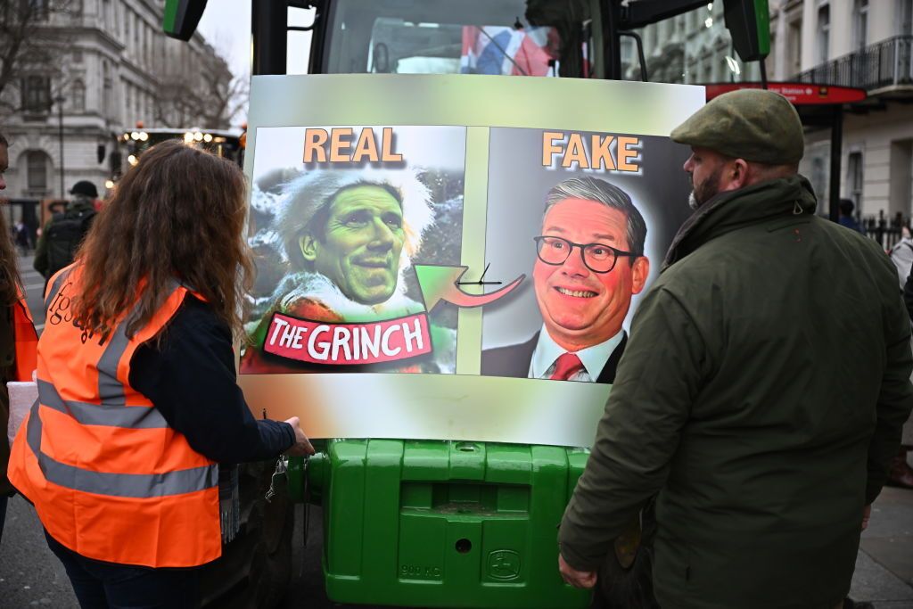 Farmers look at a poster as they attend a 