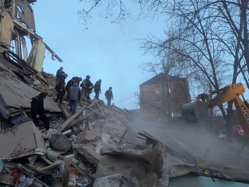 Emergency workers carry out search and rescue operations in the area hit by a Russian missile attack