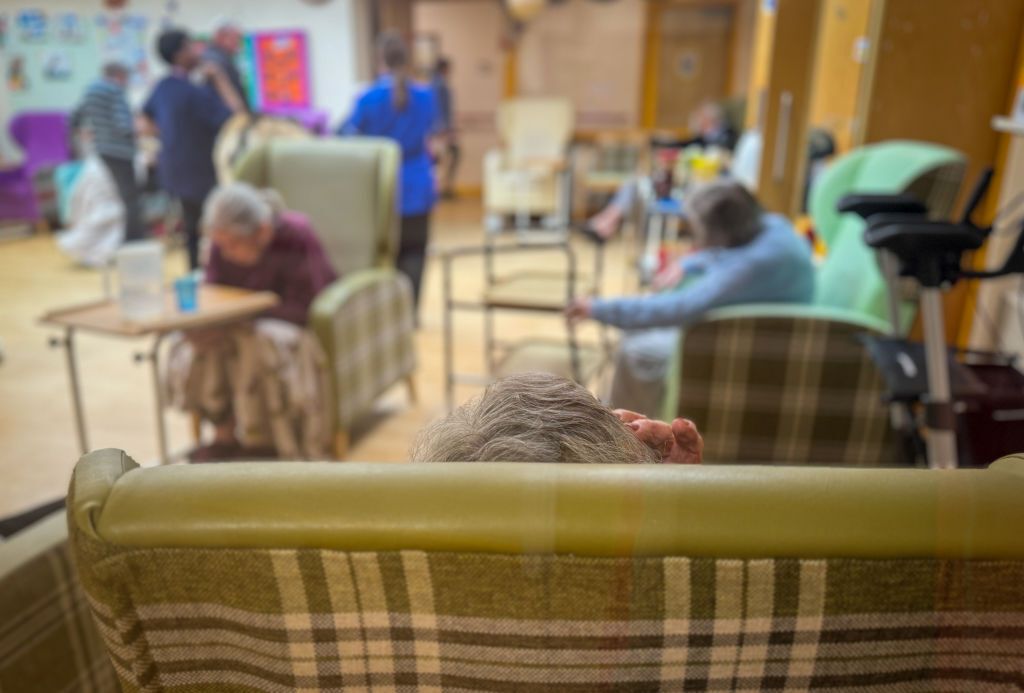 Elderly residents sit a communal area in a residential care home in Bridgwater.