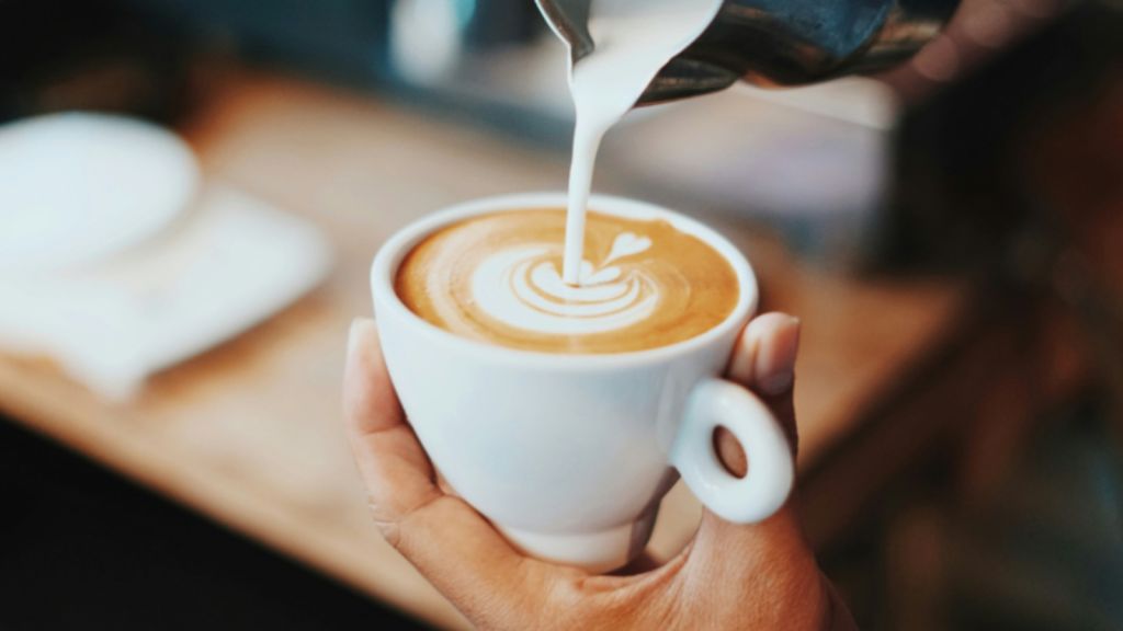 Hand holding a latte