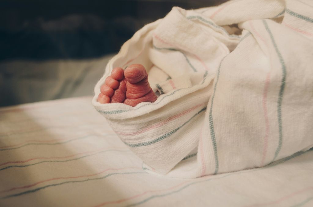 Baby's foot peeking through a blanket