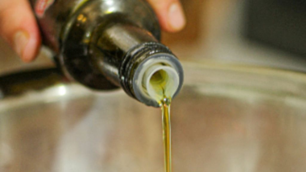 Cooking oil being poured into a bowl