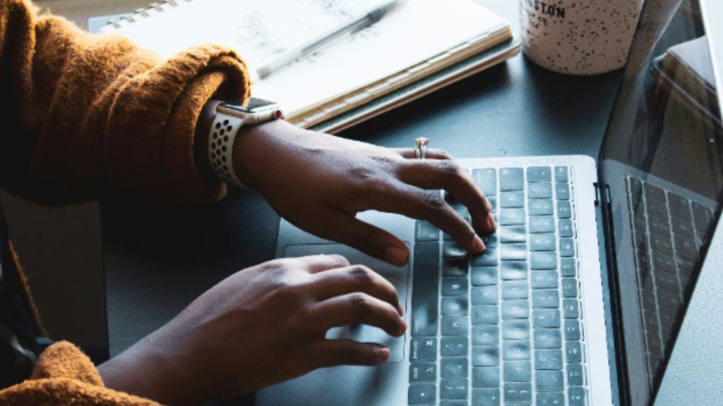 Person typing on a keyboard