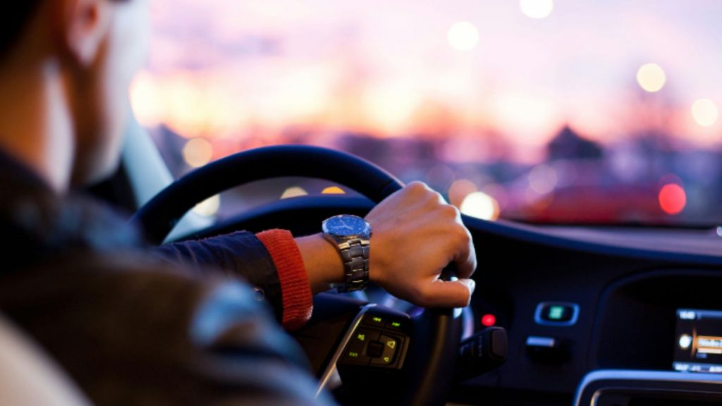 Hand on a steering wheel