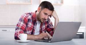 Man bored on his laptop