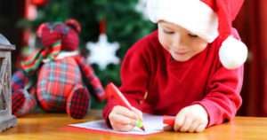 Boy writing his christmas list