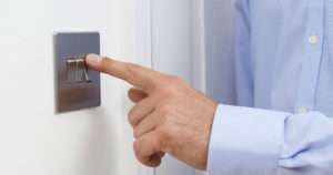 man clicking light switch