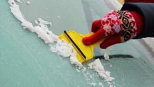 Scraping ice off a car window