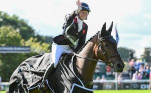 Ros Canter waves to the Burghley crowd on her lap of honour with Lordships Graffalo