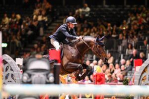 Wilm Vermeir and home-bred stallion Top Invest 313 Z win the Ivy Stakes at the London International Horse Show on the opening day of showjumping, despite power blackouts.