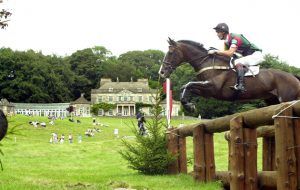 Moon Man, ridden by William Fox-Pitt, jumps the fence with the house in the background at Gatcombe Park, to go on to win the the Doubleprint British Open horse trials Championship.