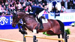 Oli Fletcher jumps Cajus 42 over an oxer at the London International Horse Show