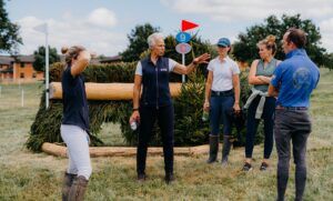 The late Caroline Moore coaching riders while walking a cross-country course