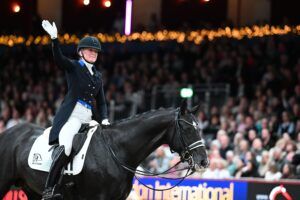 Nanna Skodborg Merrald waves to the crown from the saddle of Blue Hors St. Schufro after contesting the FEI Dressage World Cup qualifier at the 2024 London International Horse Show.