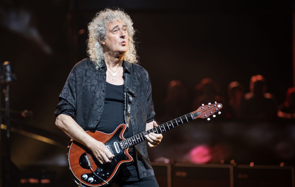 Brian May performing live on stage with Queen