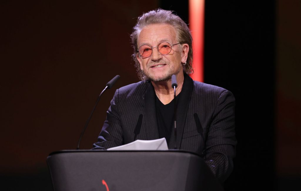 U2 singer and frontman Bono speaks on stage